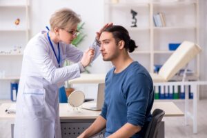 Doctor examining patient to see if he is eligible for mohs surgery on nose.