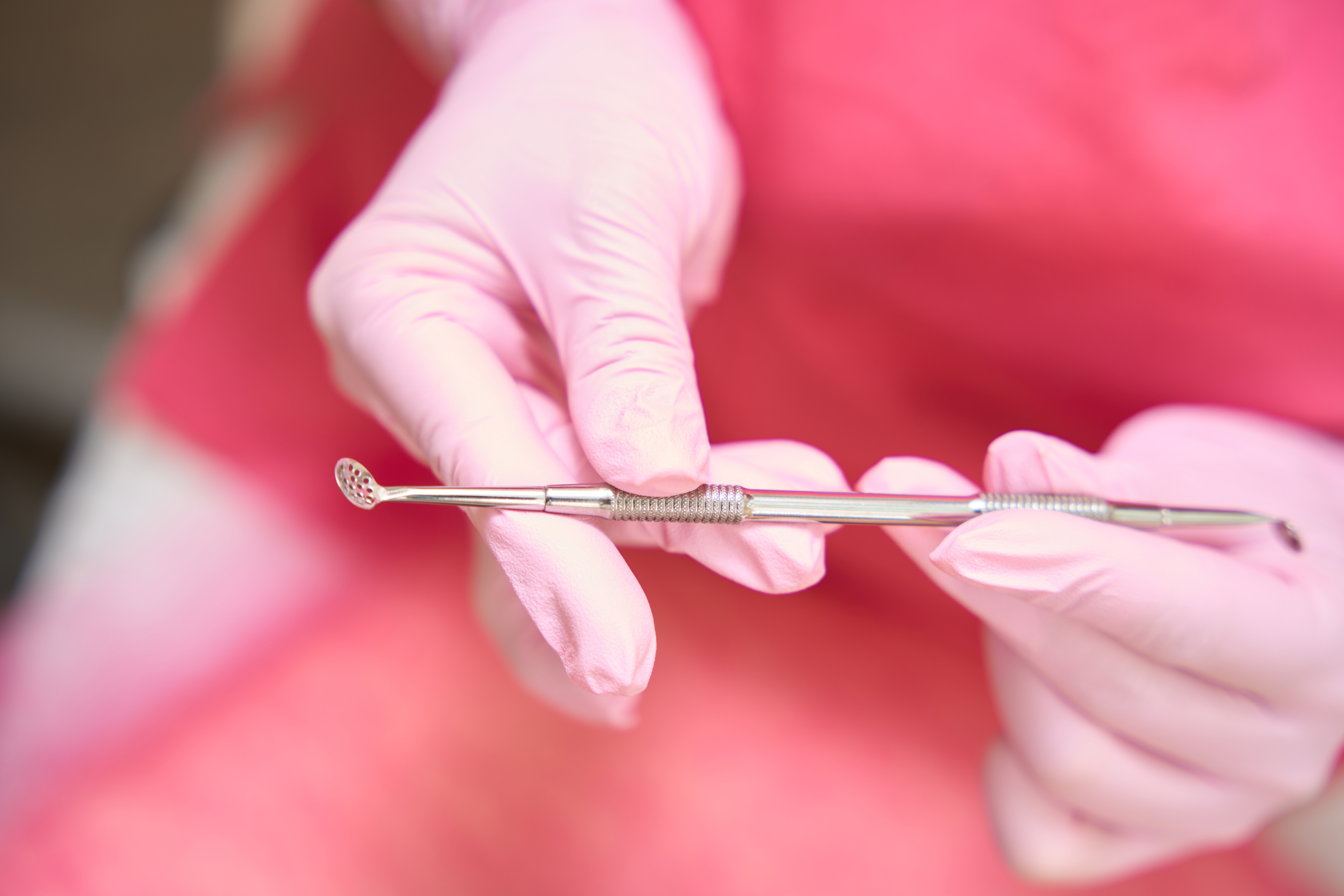 Dentist holding dental mirror and explorer tools