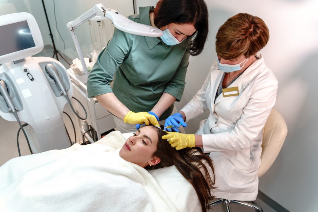 Woman scalp treatment by medical professionals