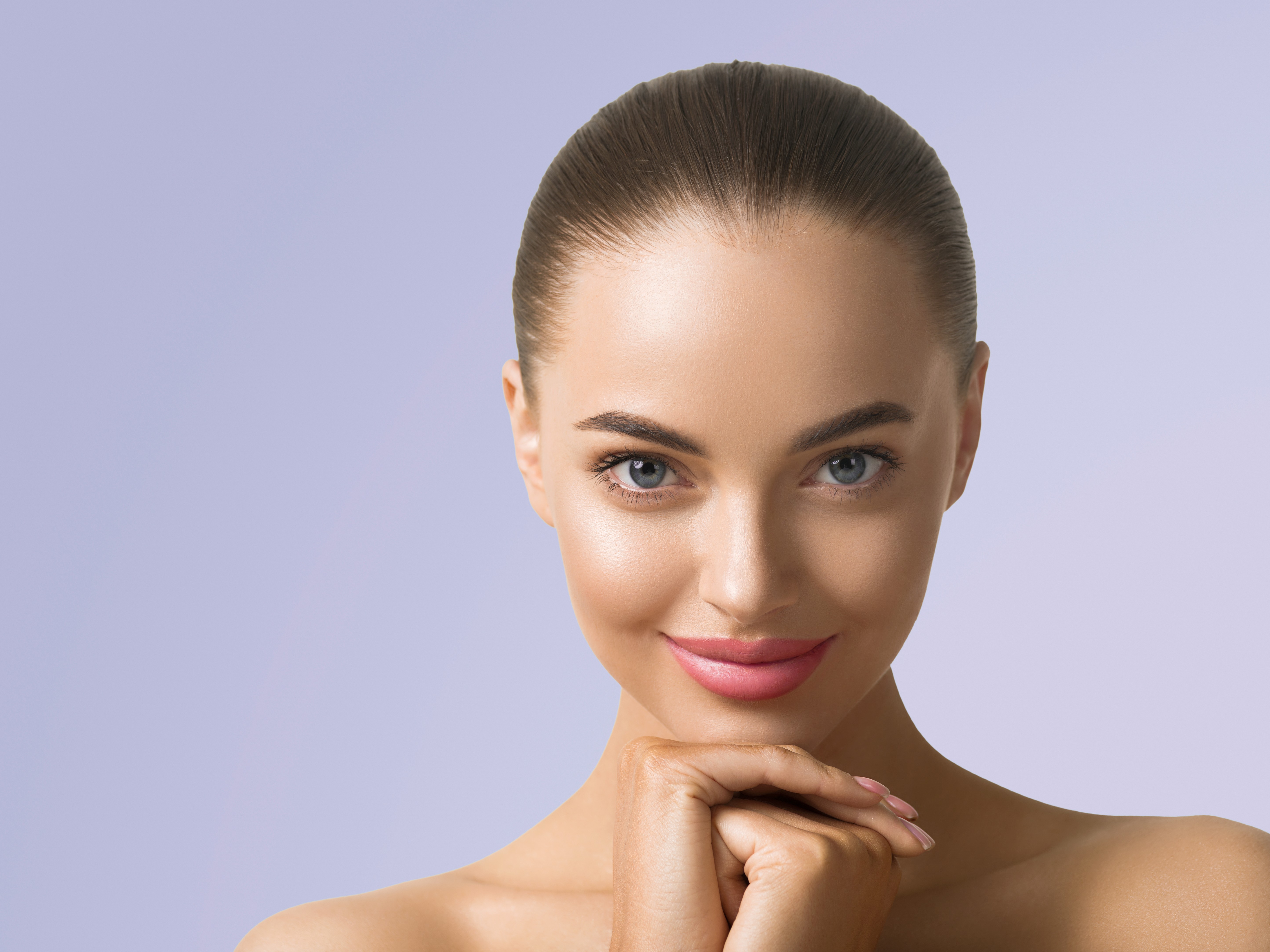 Woman with glowing skin smiling gently