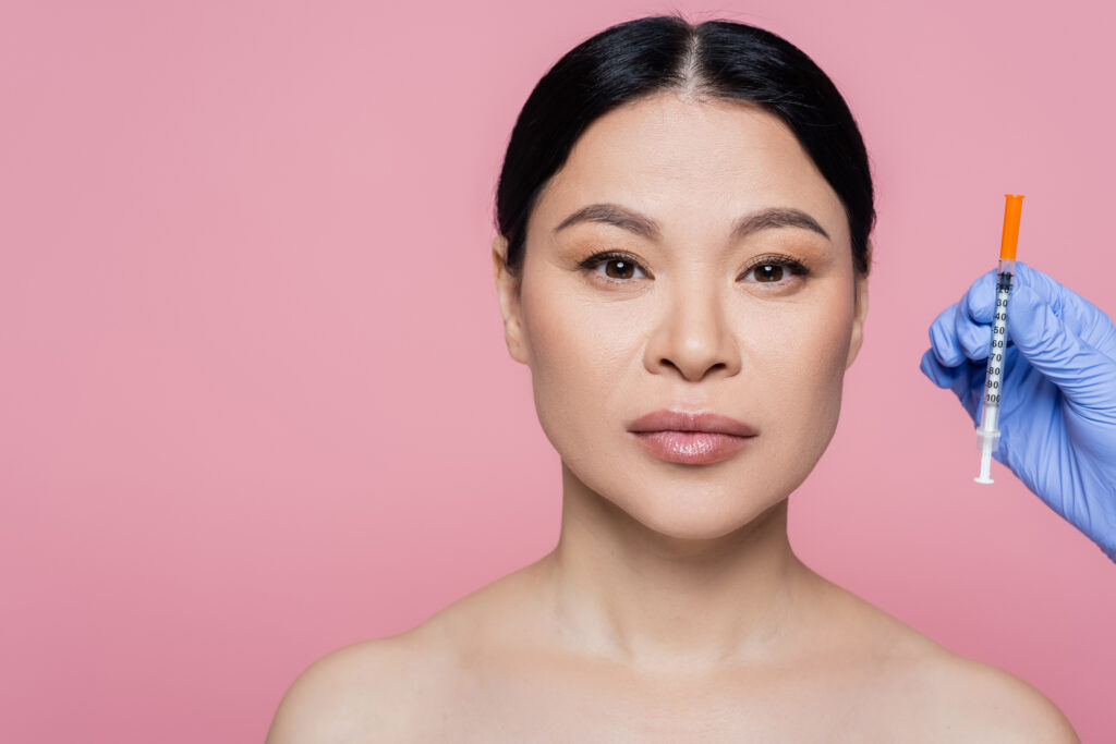 Woman with syringe for cosmetic injection